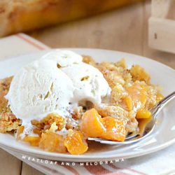 peach cobbler with cake mixed topping and ice cream