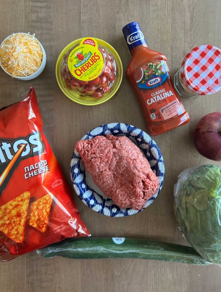 doritos, ground meat, catalina dressing, lettuce, cheese and salad ingredients