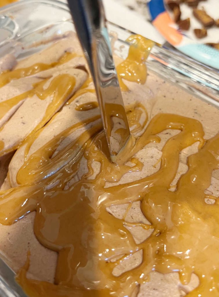 swirl melted peanut butter into ice cream with knife