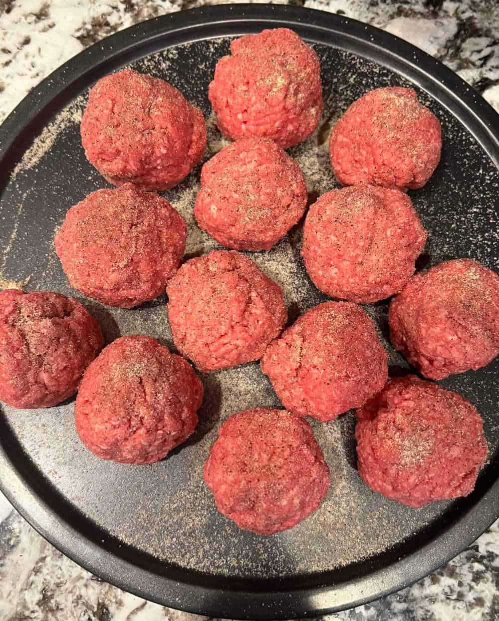 ground beef burger balls on tray.