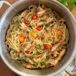 spaghetti with fresh tomatoes and basil and grilled chicken in a pot.