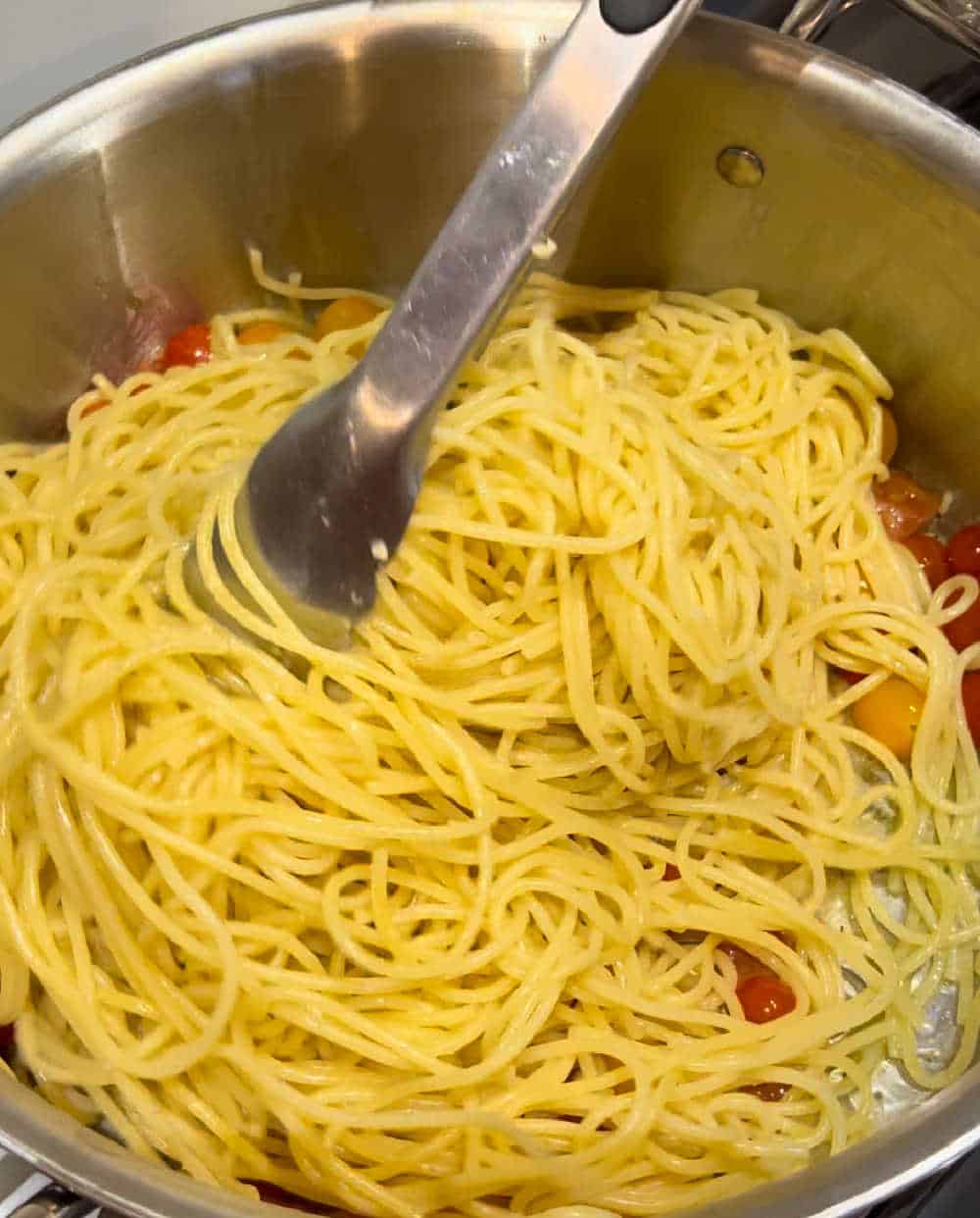 toss cooked pasta with tomatoes.