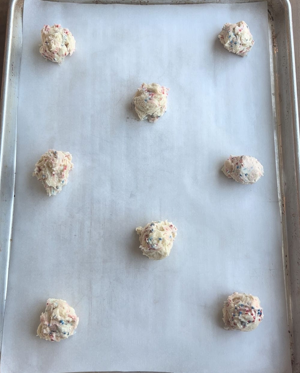 cookie dough balls on baking sheet.