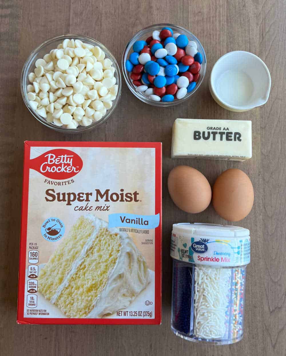 cake mix, white chocolate chips, m&m's, milk, butter, eggs, sprinkles.