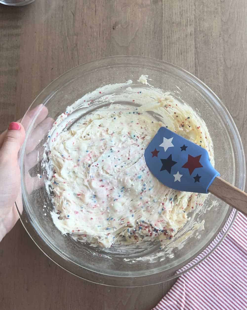 stir sprinkles in cookie dough with star spatula.