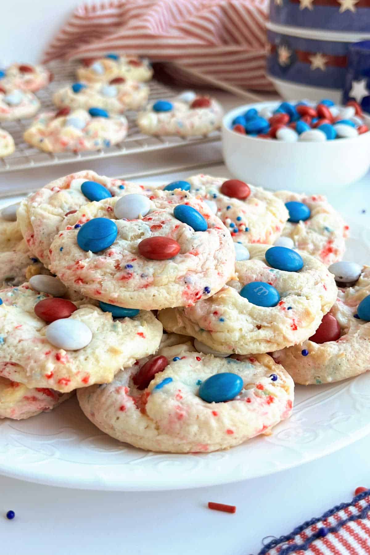 patriotic 4th of July cookies with sprinkles and m&m's on the table.