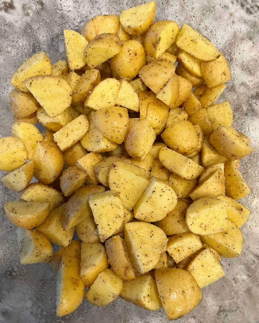 seasoned potatoes in mixing bowl.