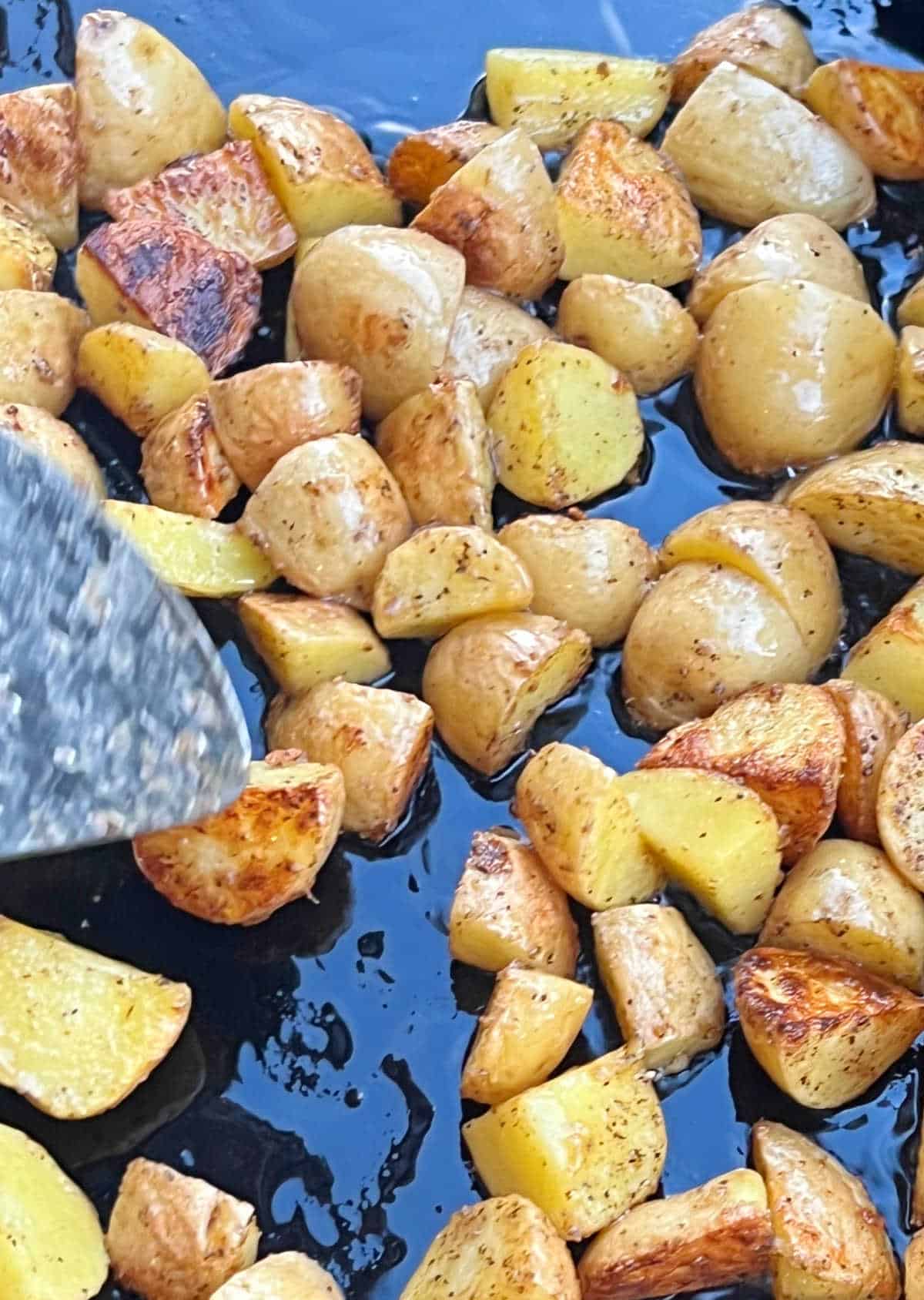 toss potatoes with grilling spatula.