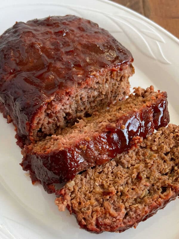 smoked meatloaf with bbq glaze on white platter.