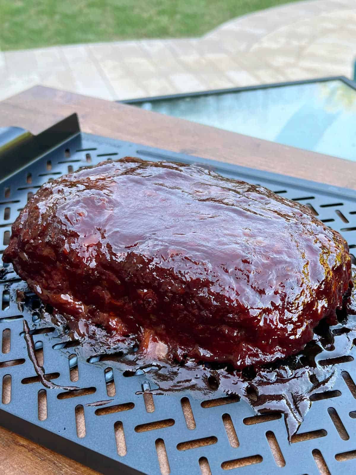 meatloaf cooked in smoker with bbq glaze in backyard.