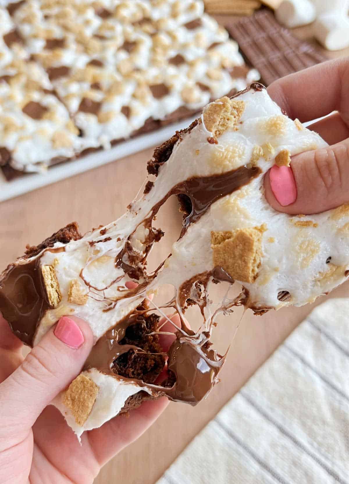 pull smores brownie apart with gooey marshmallows.