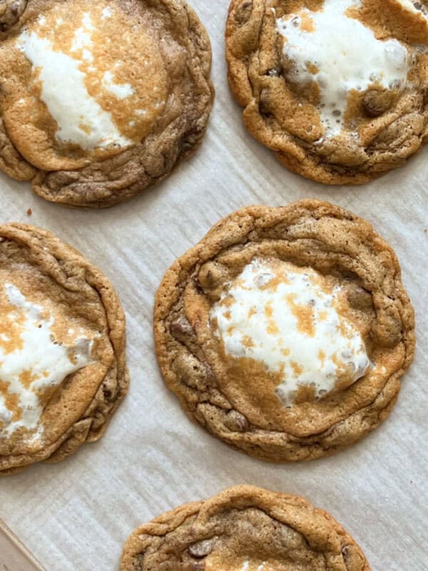 smores cookies with melted marshmallows on baking sheet.