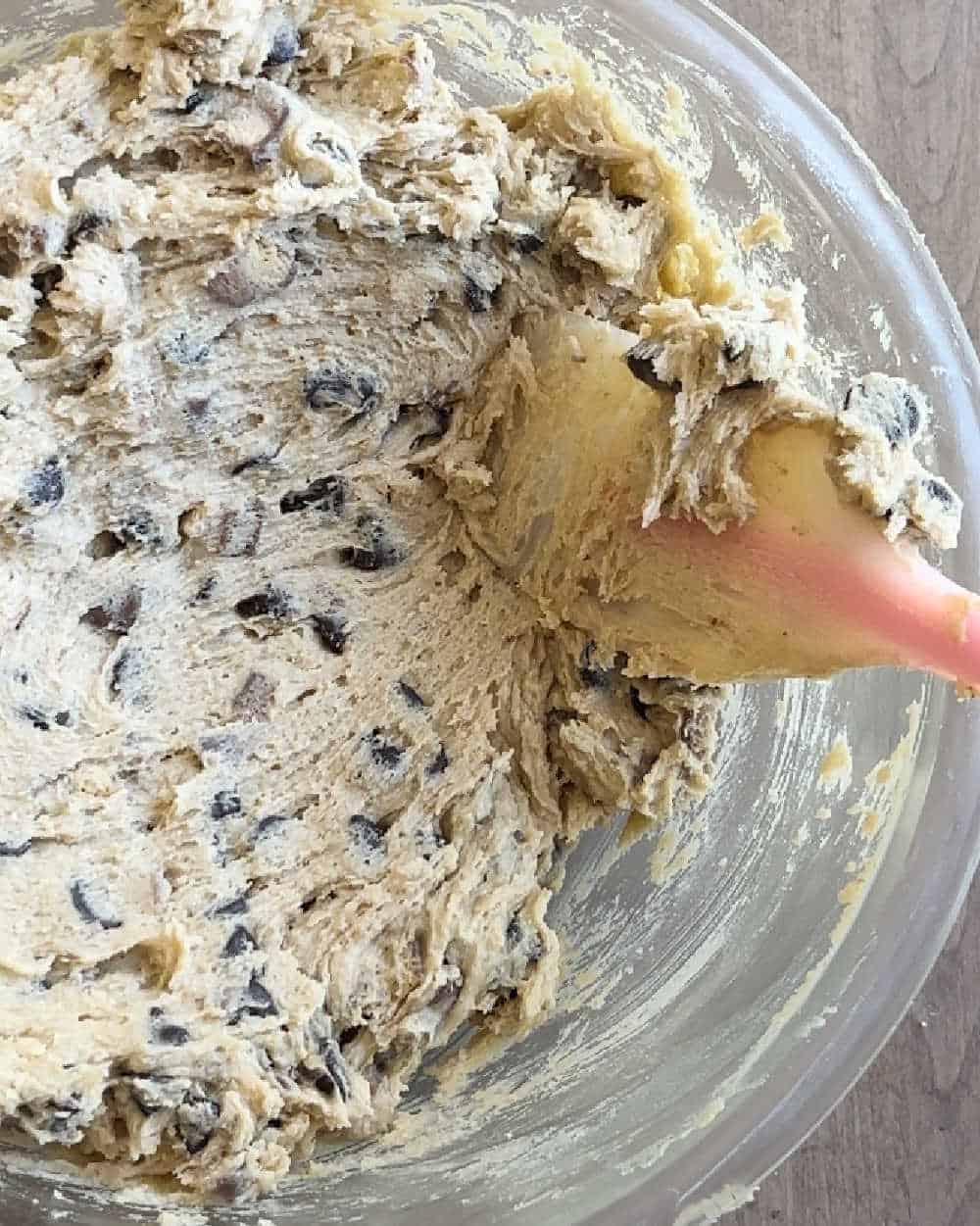 stir chocolate candy into cookie dough with spatula.