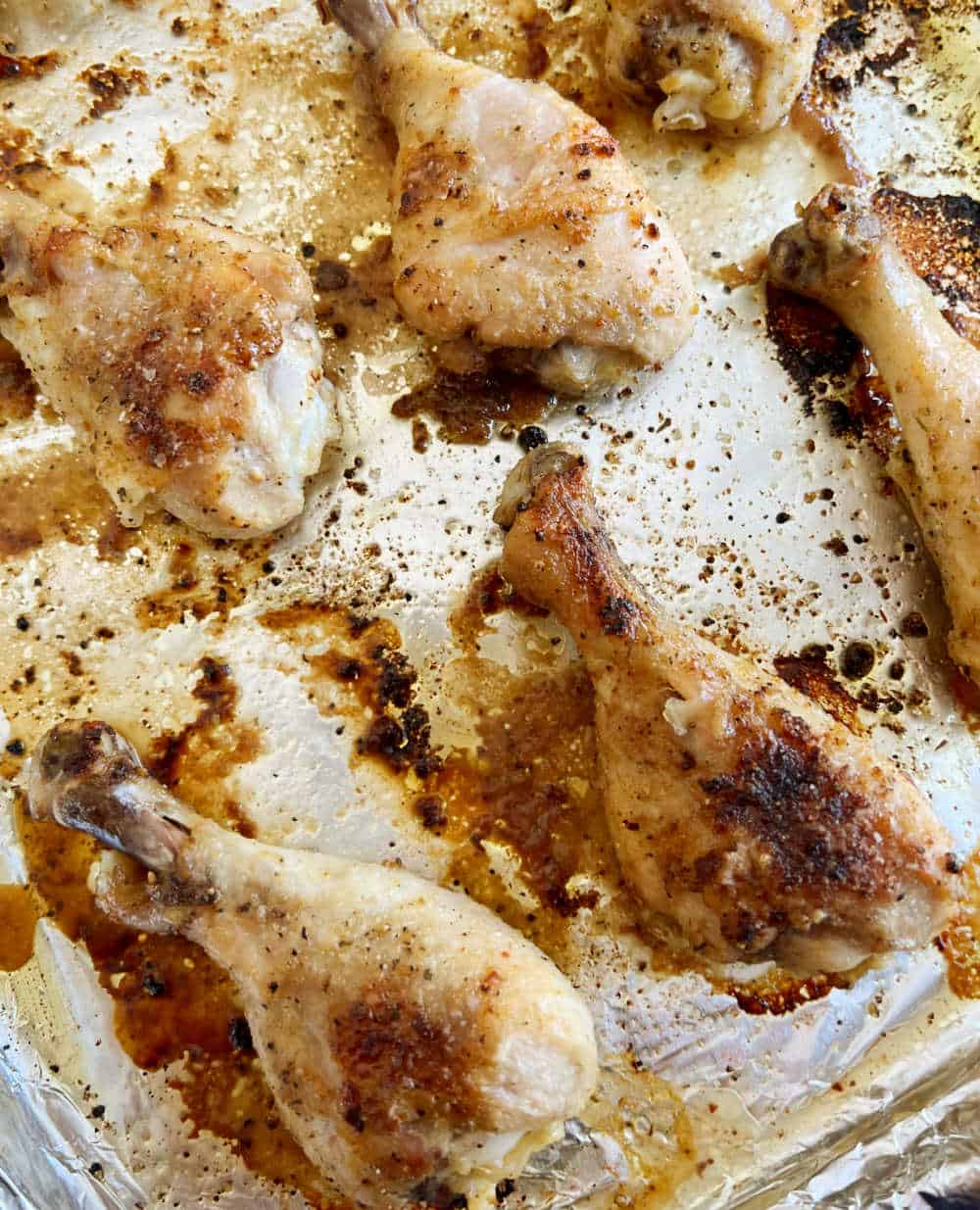 oven baked chicken drumsticks on baking sheet.