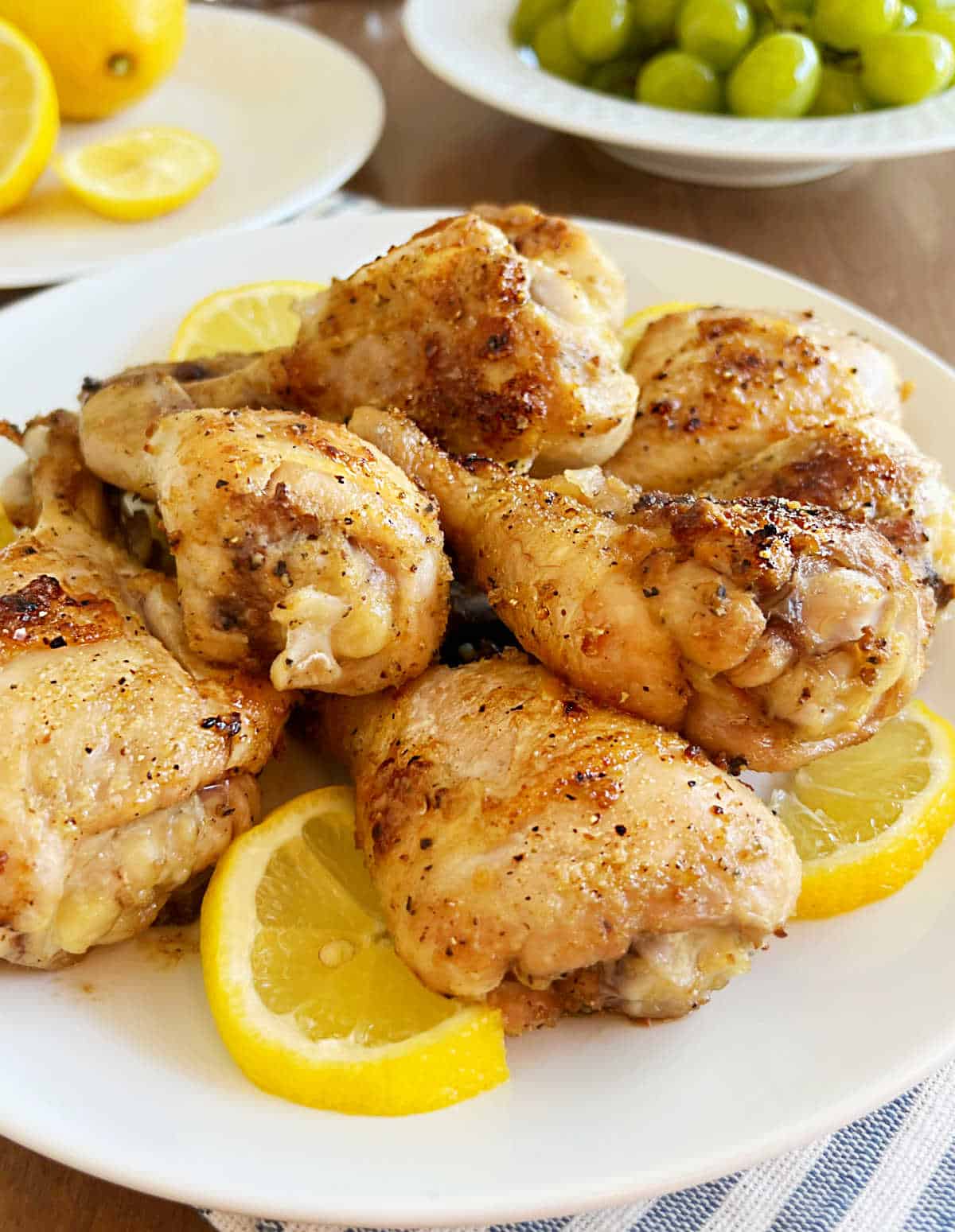 plate of oven baked chicken legs on the table.