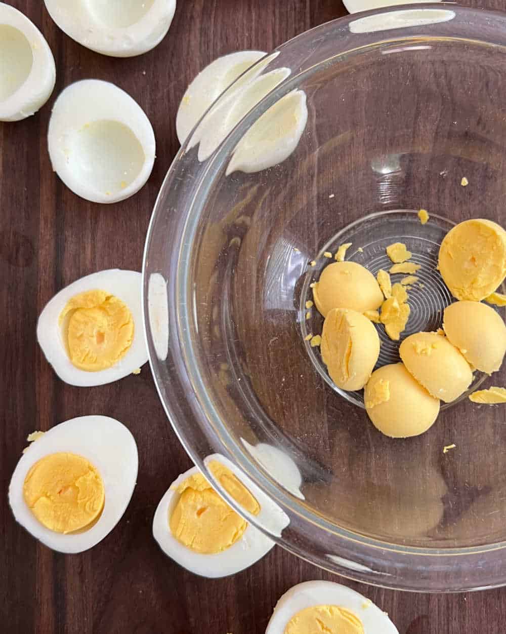 sliced hard boiled eggs with yolks in bowl.
