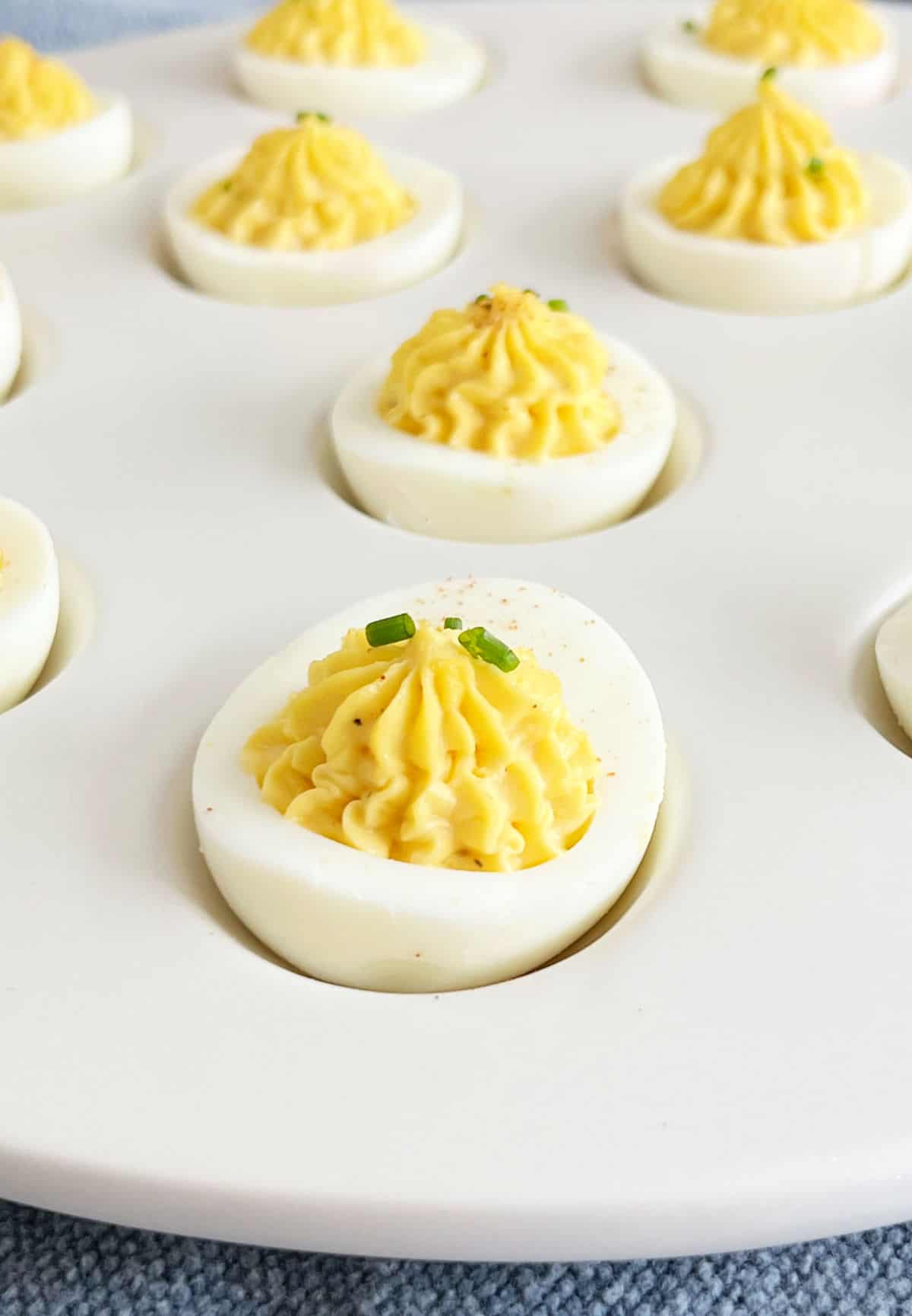 deviled egg with chives and paprika.