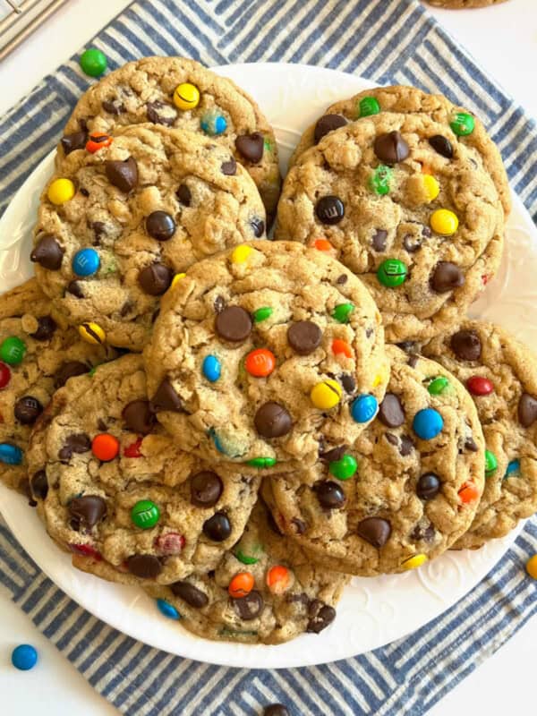 monster cookies stacked on a plate.