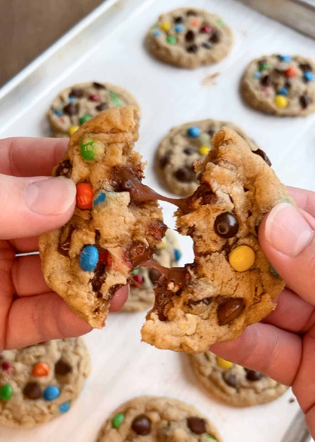 pull monster cookie apart with hands.