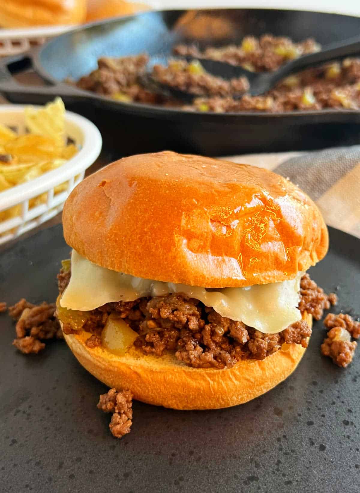 Philly cheesesteak sloppy joes sandwich on a plate.