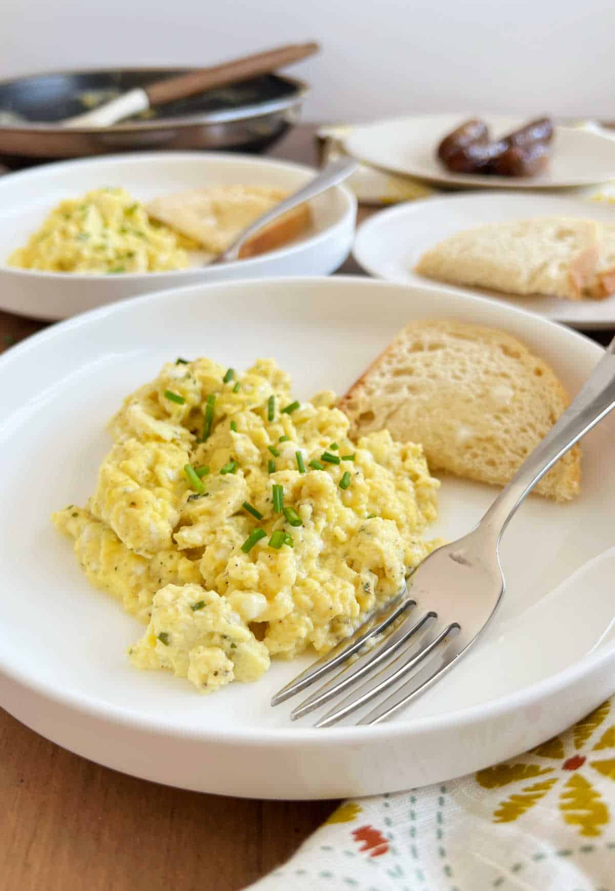 plates of cottage cheese scrambled eggs on the breakfast table.