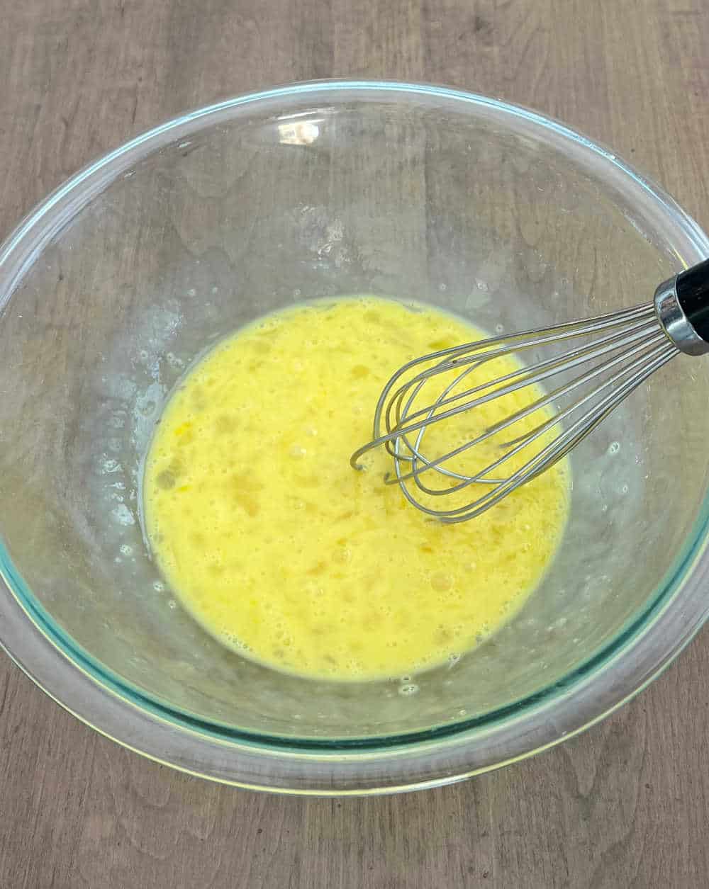 whisk eggs in mixing bowl.