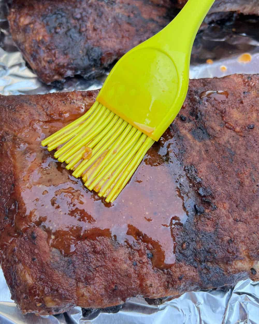 brush bbq sauce on smoked ribs.