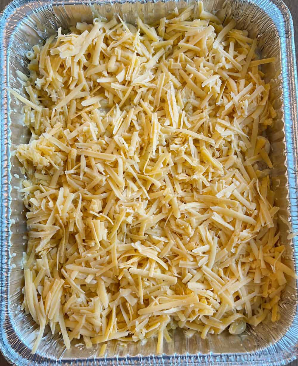 top mac and cheese with shredded cheese in pan.
