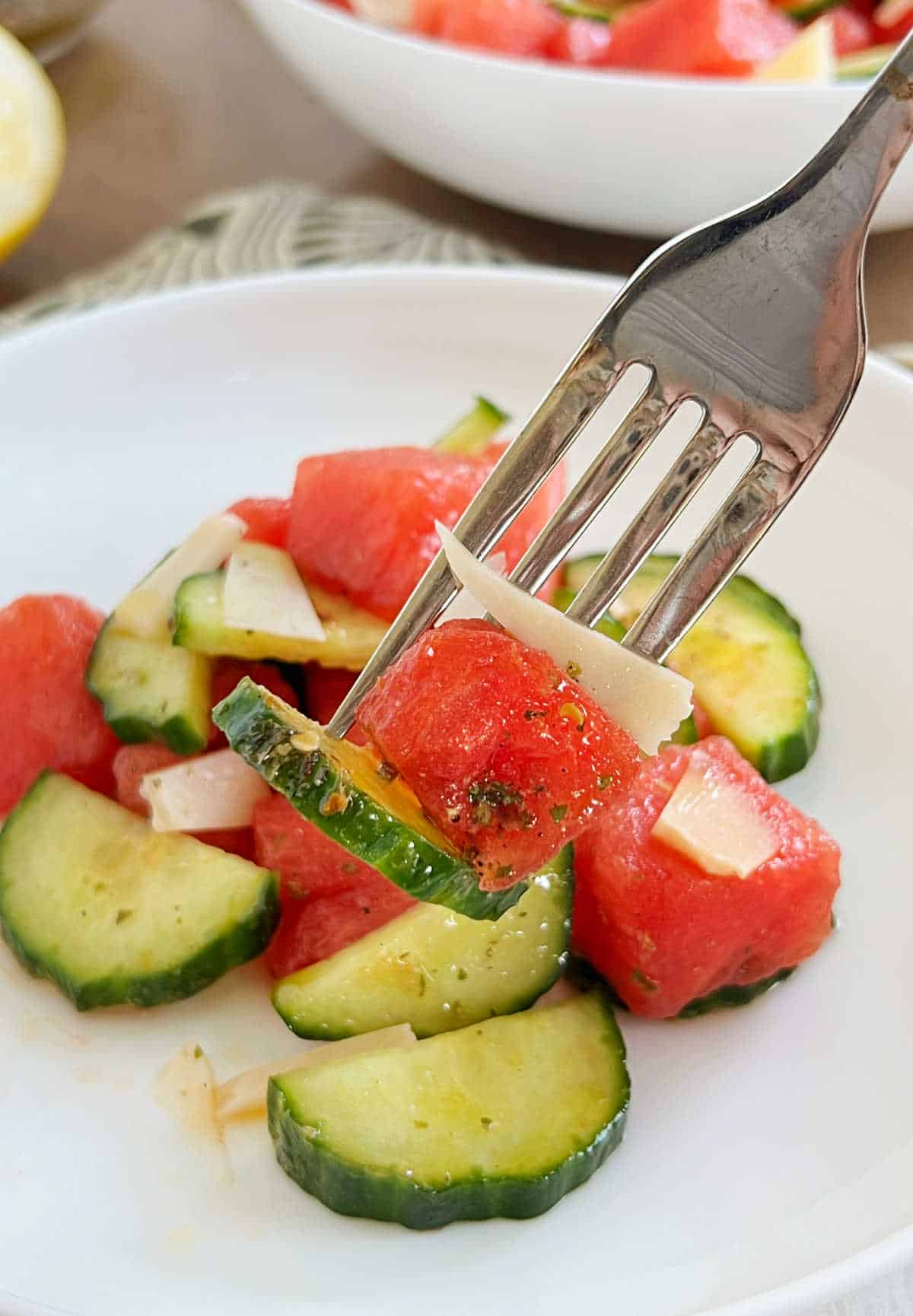 watermelon, cucumber and goat cheese on fork.