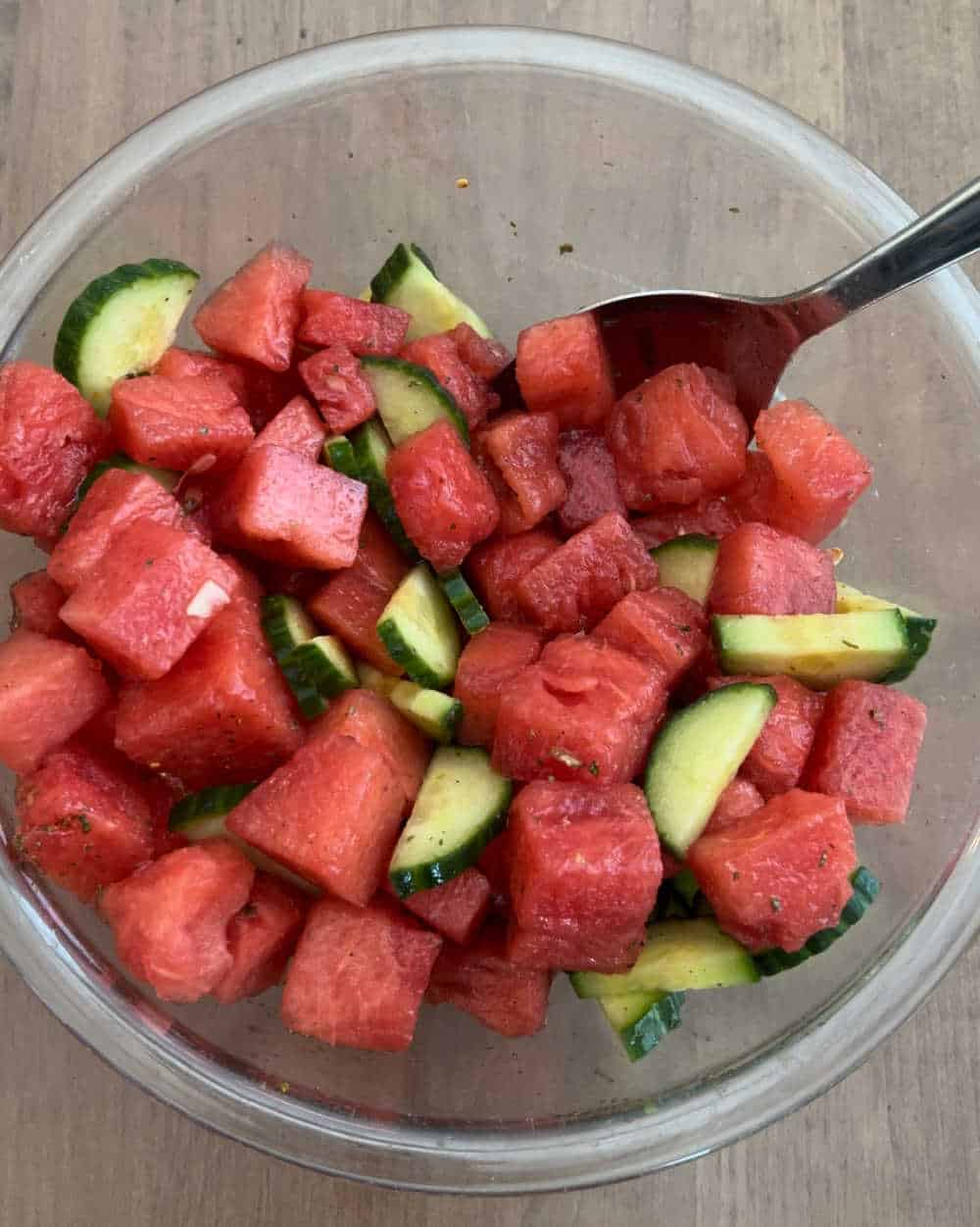 stir cubed watermelon and cucumbers with dressing.