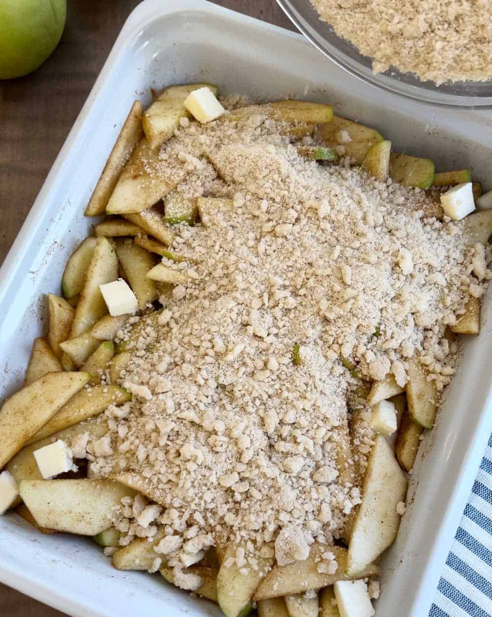 sprinkle topping over apples in baking dish.