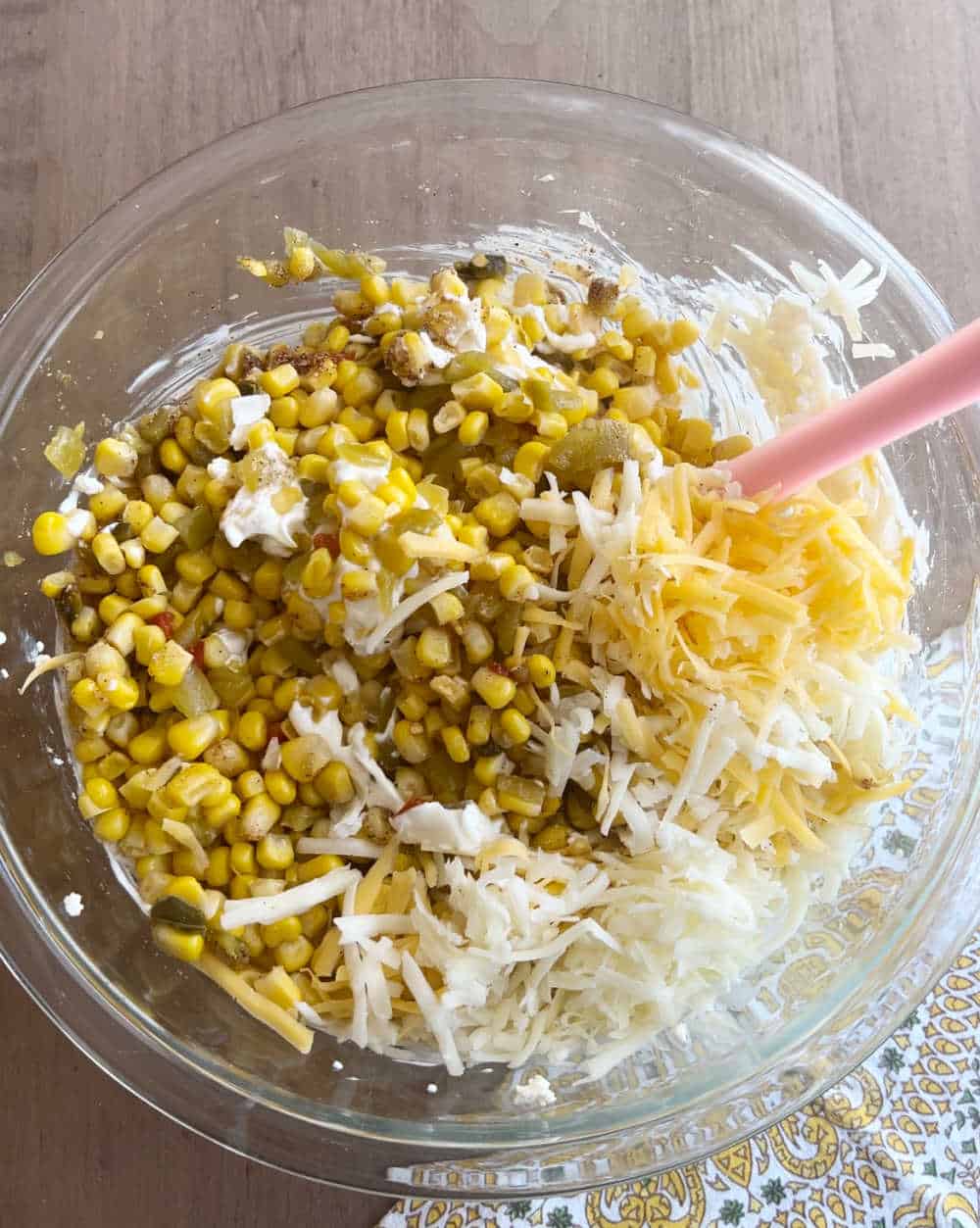 stir corn and cheese with cream cheese with spatula.