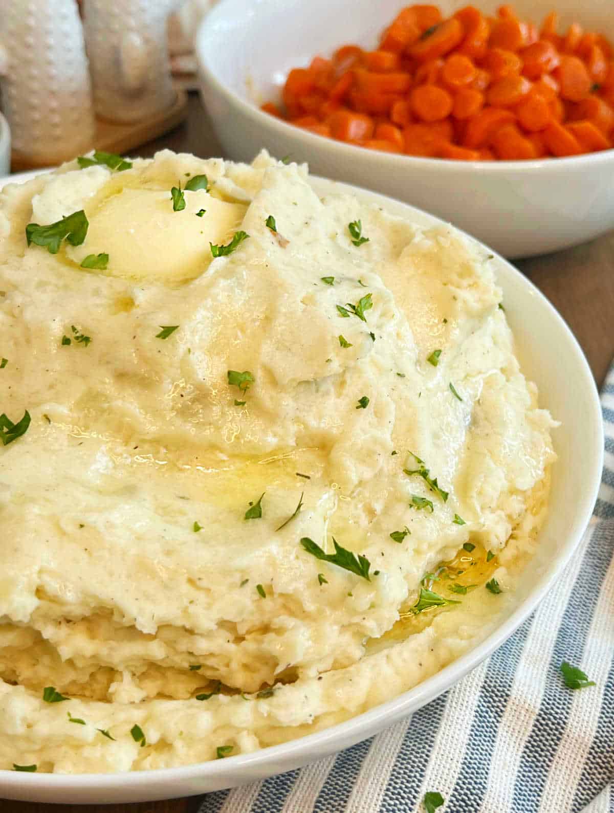 cream cheese mashed potatoes with butter in serving bowl.