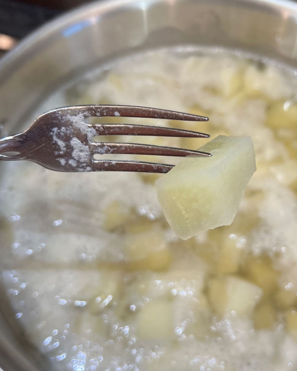 pierce boiled potatoes with fork.