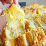 cheesy pull apart bread with melty cheese in hand.