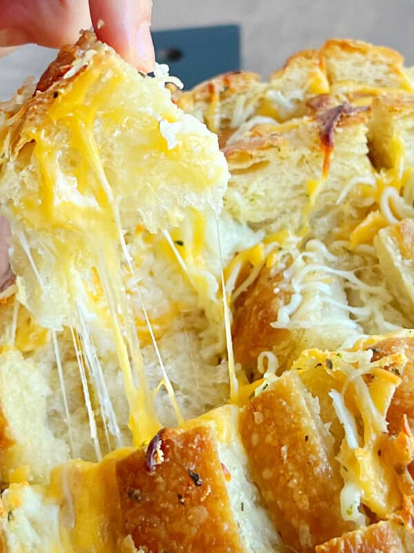 cheesy pull apart bread with melty cheese in hand.