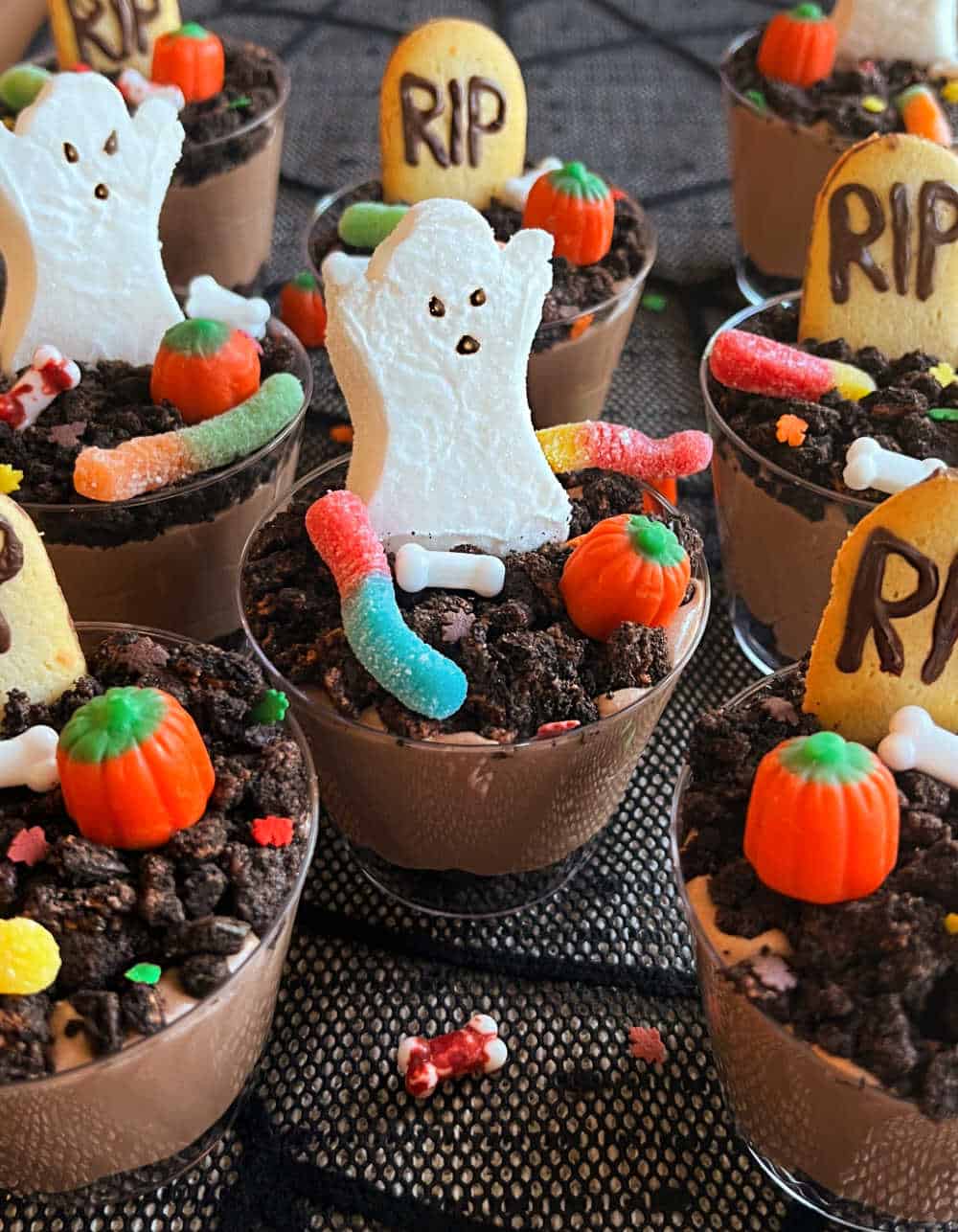 graveyard pudding cups on halloween dessert table.