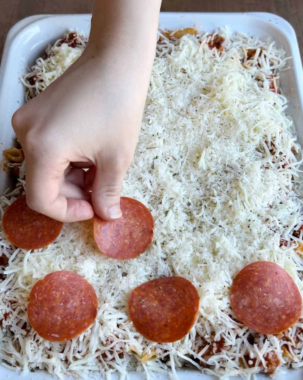 top casserole with cheese and pepperoni slices.