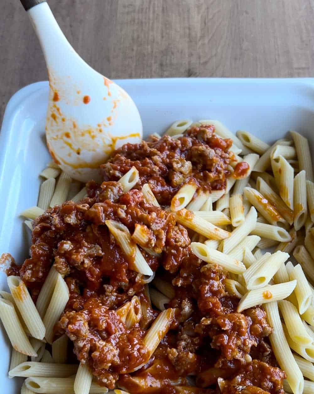 mix sauce with cooked pasta in baking dish.