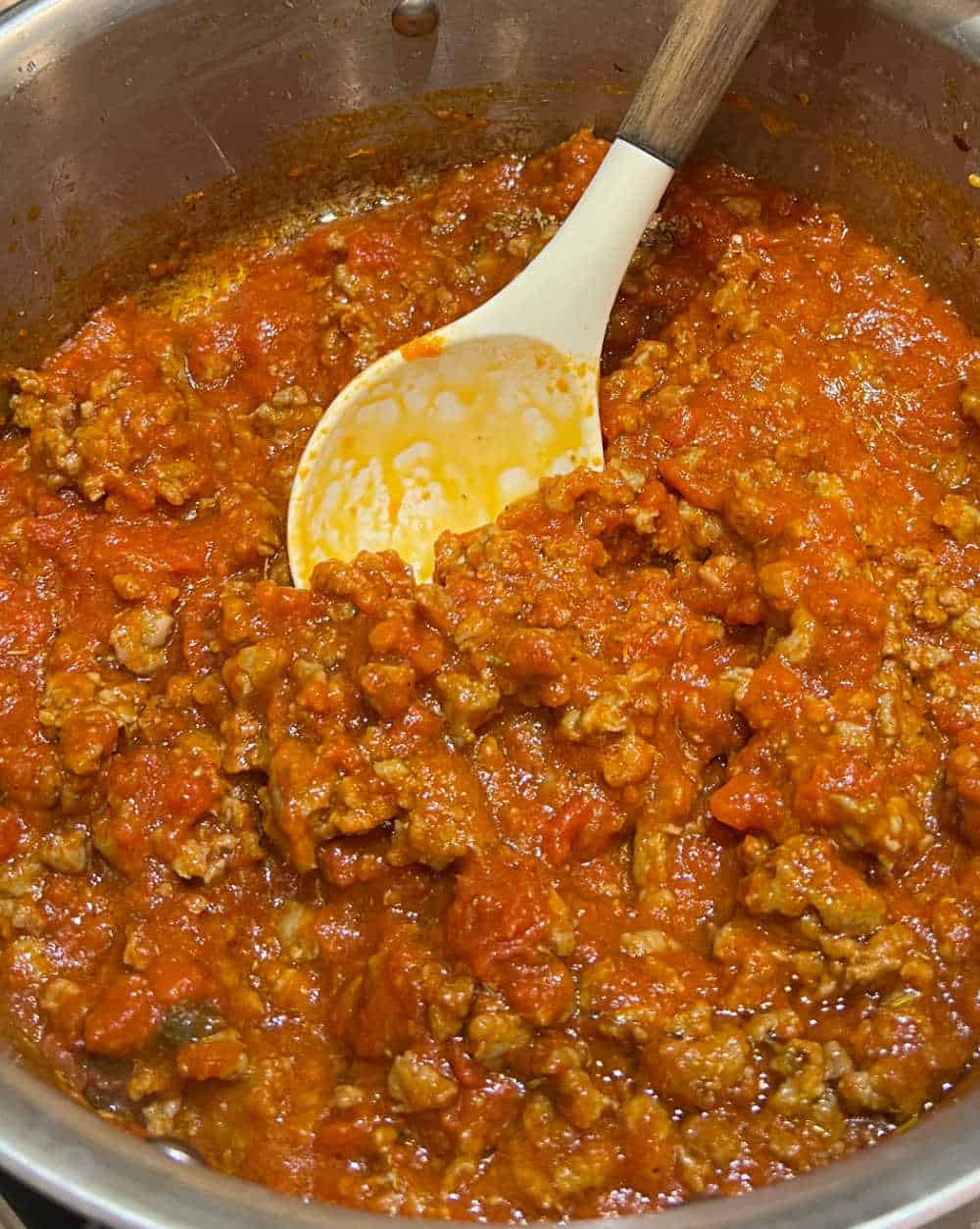 stir sausage and marinara sauce in pan.