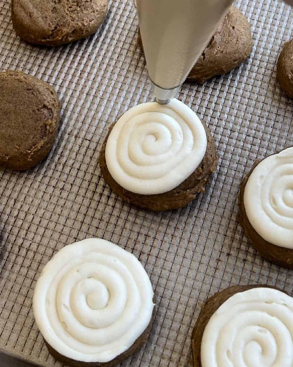 pipe frosting on pumpkin cake mix cookies.