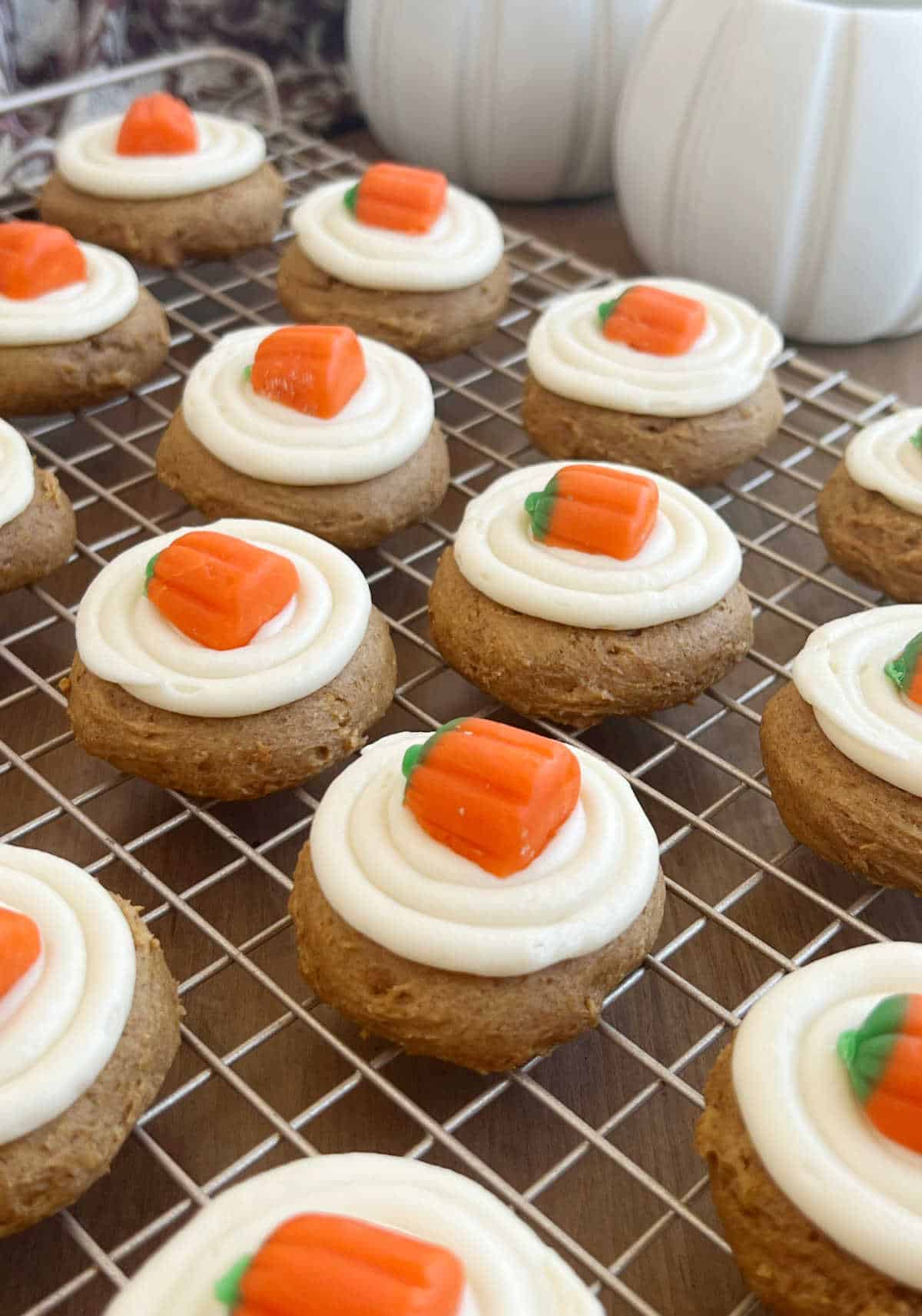 cake mix pumpkin cookies with cream cheese frosting on wire rack.