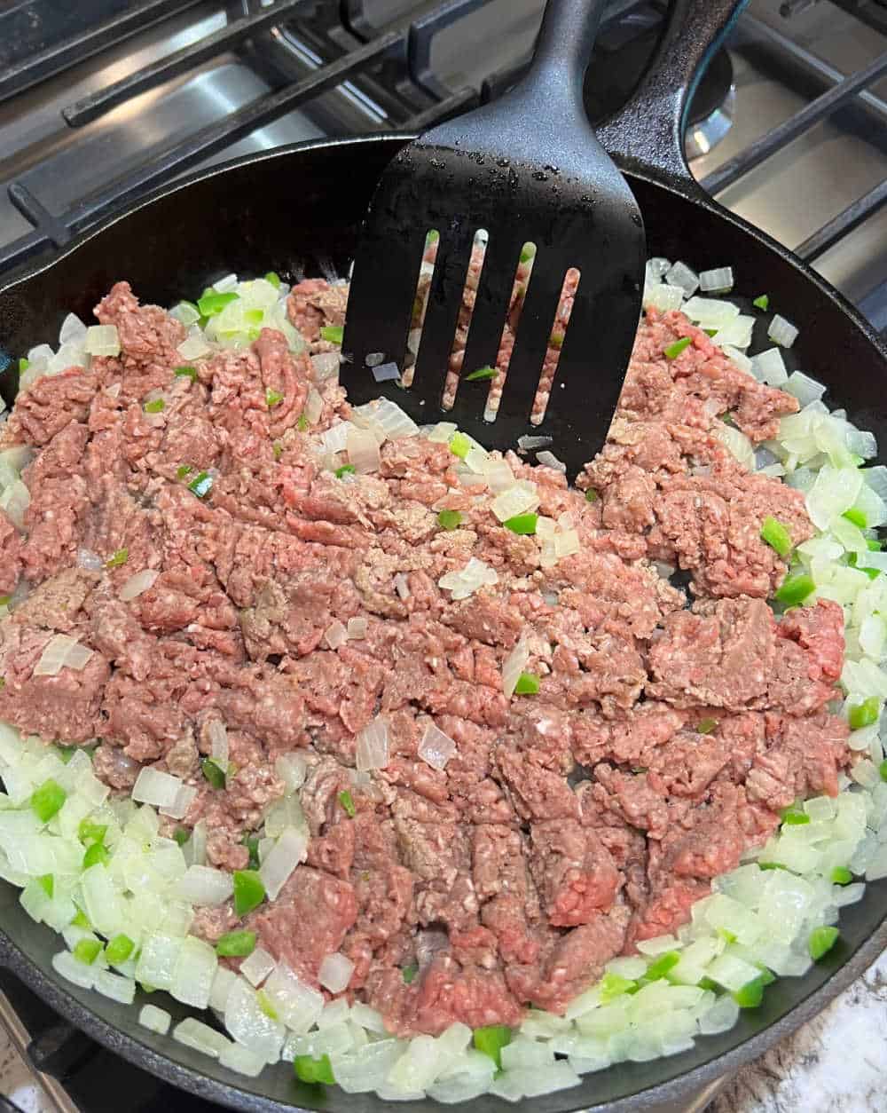 cook ground beef with onion and peppers in skillet.