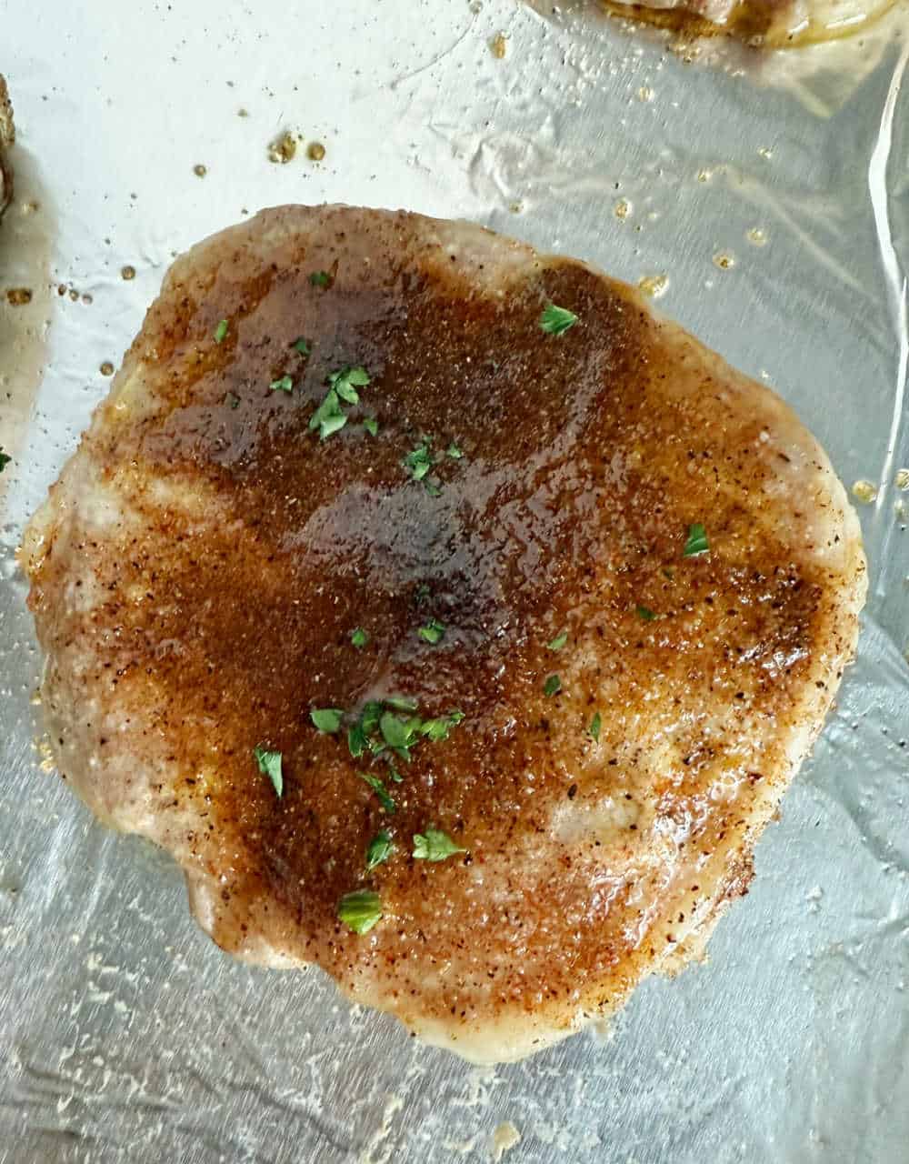 baked pork chop with brown sugar and parsley.