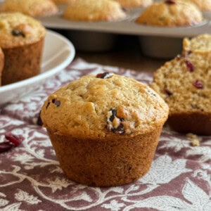 banana cranberry muffins made with dried cranberries on the table.