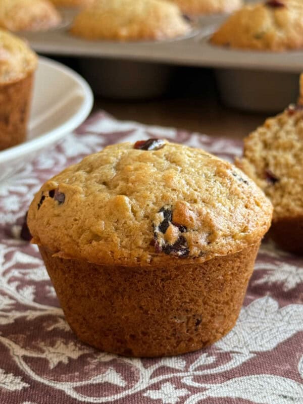 banana cranberry muffins made with dried cranberries on the table.