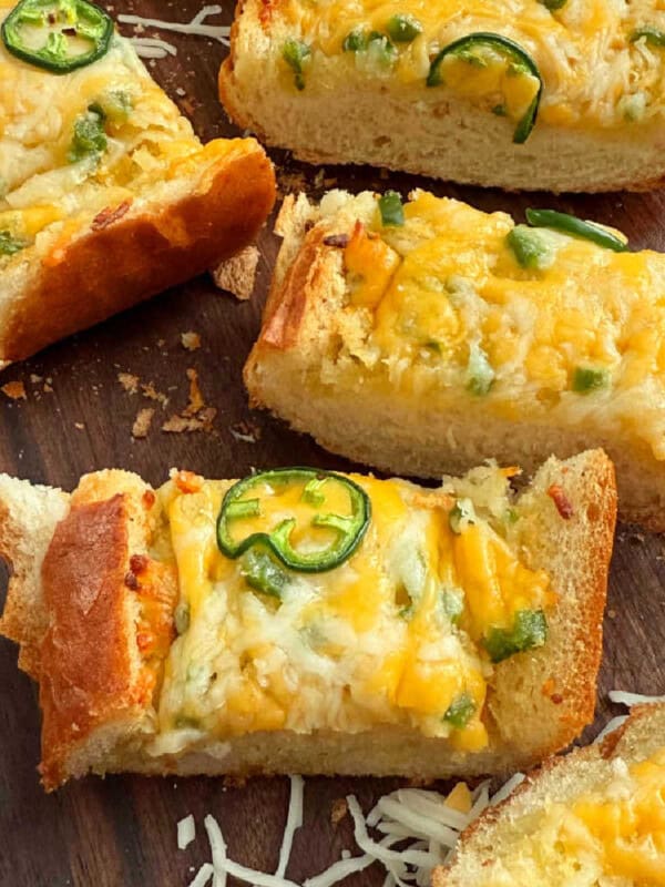 slices of cheesy garlic bread with jalapeno peppers.