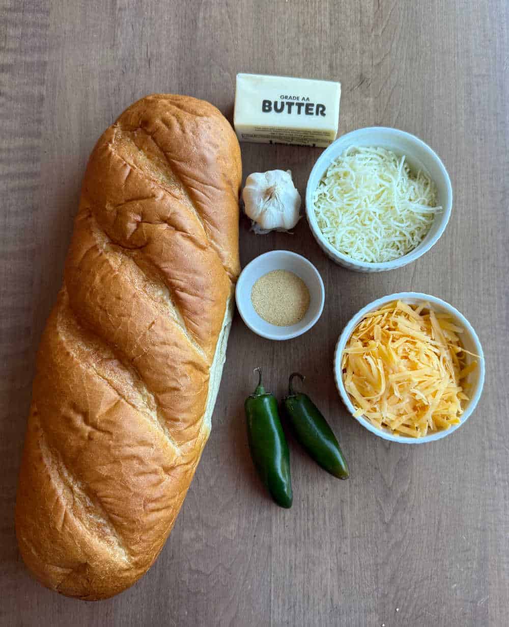 ingredients for garlic cheese bread on table.