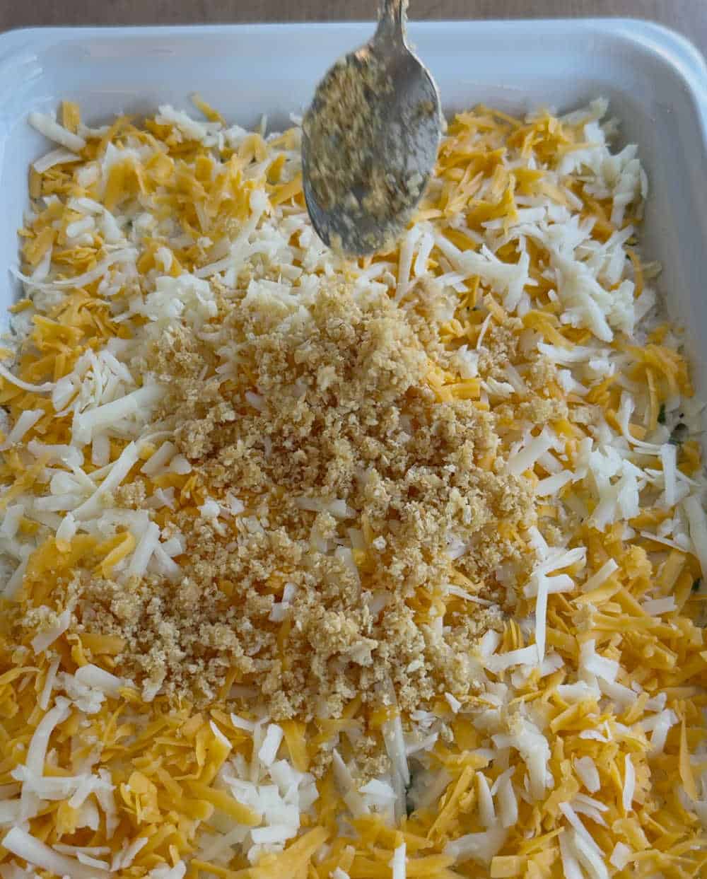 add cracker crumbs over cheese layer.