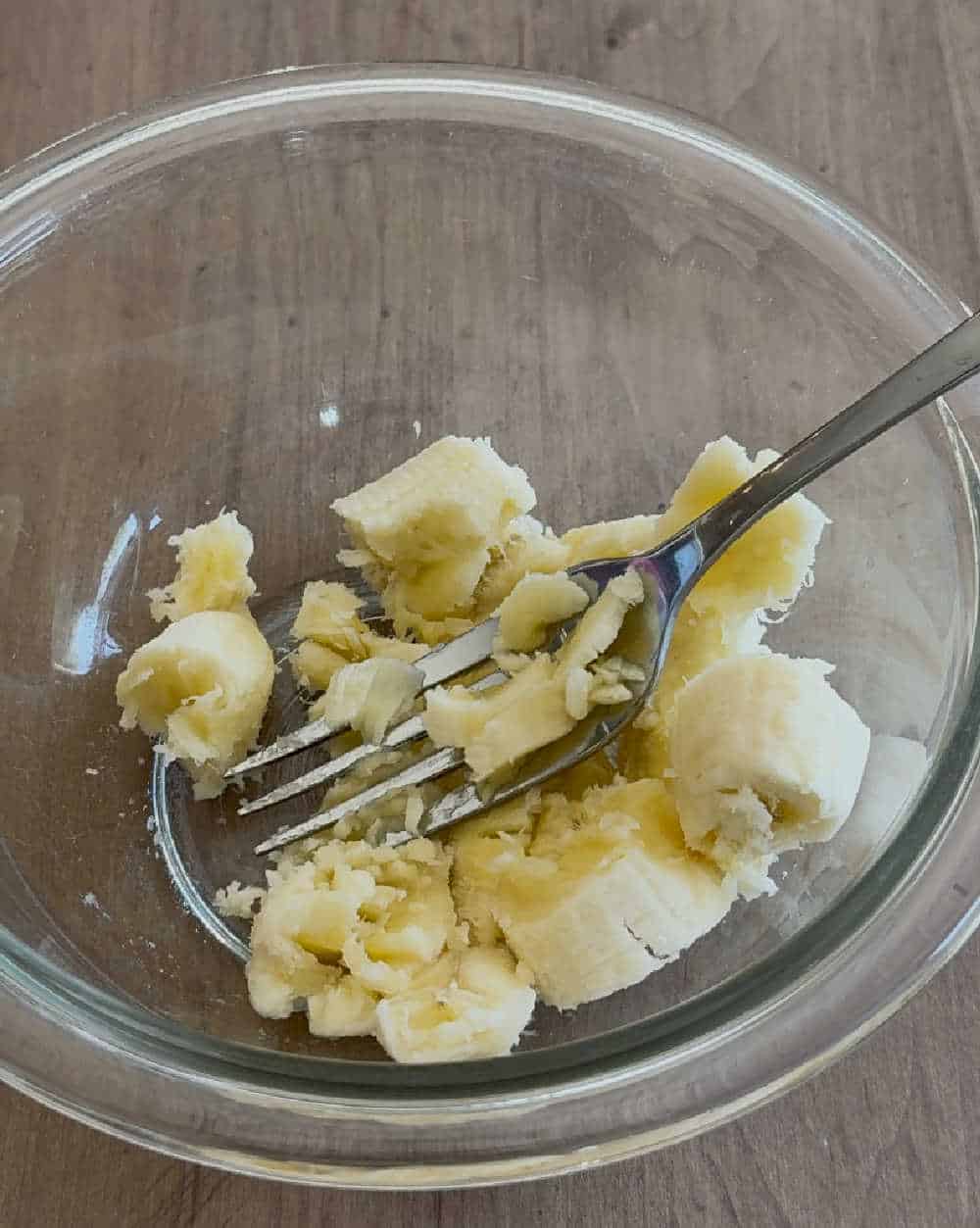 mash banana with fork.